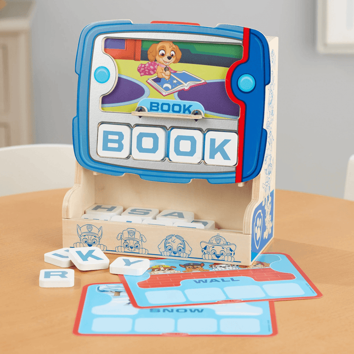 wooden pup pad on table top with graphic cards and letter tiles to the side