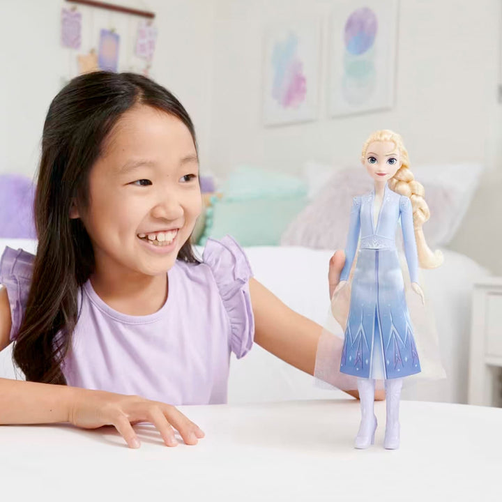 Girl playing with a Disney Frozen Elsa fashion doll