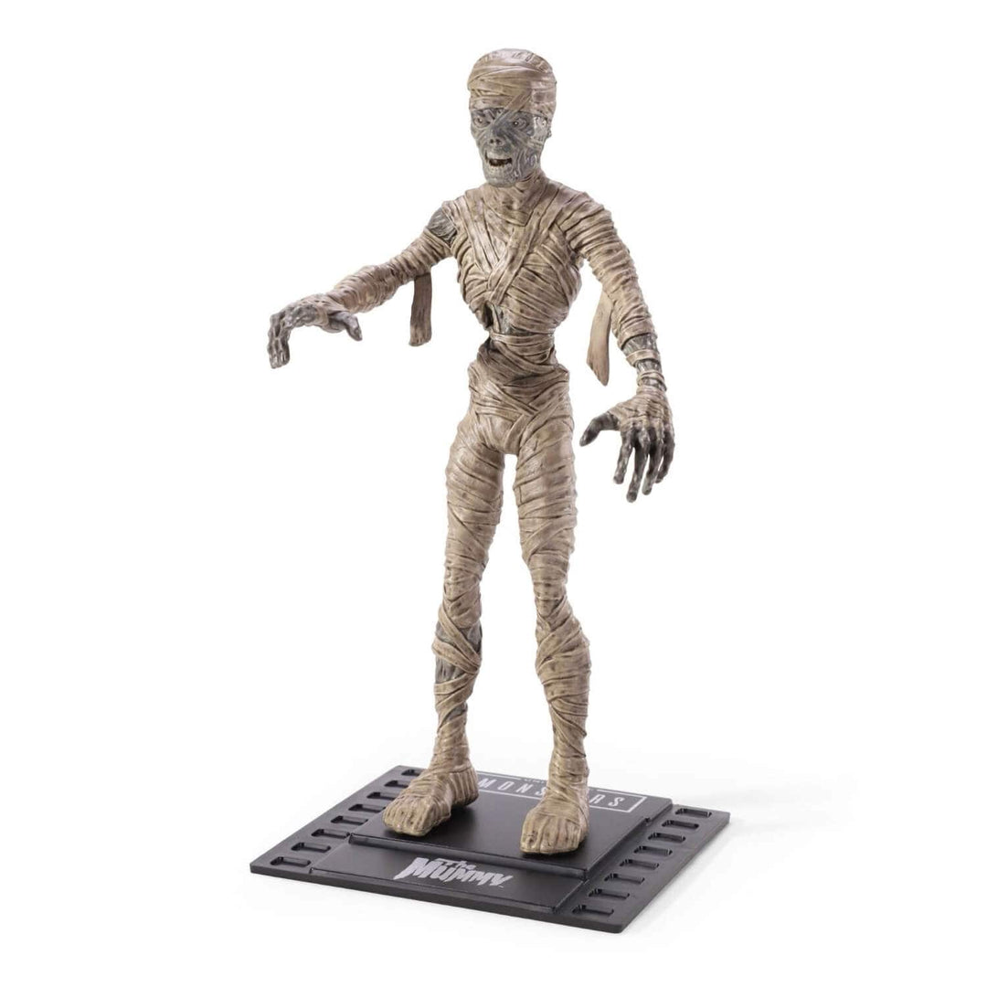 A Mummy action figure standing on a black display base with the title 'Mummies' visible, photographed against a plain white background.