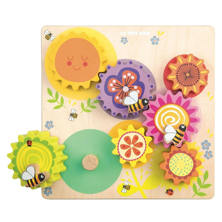 Colorful wooden puzzle with flowers and bees on a white background