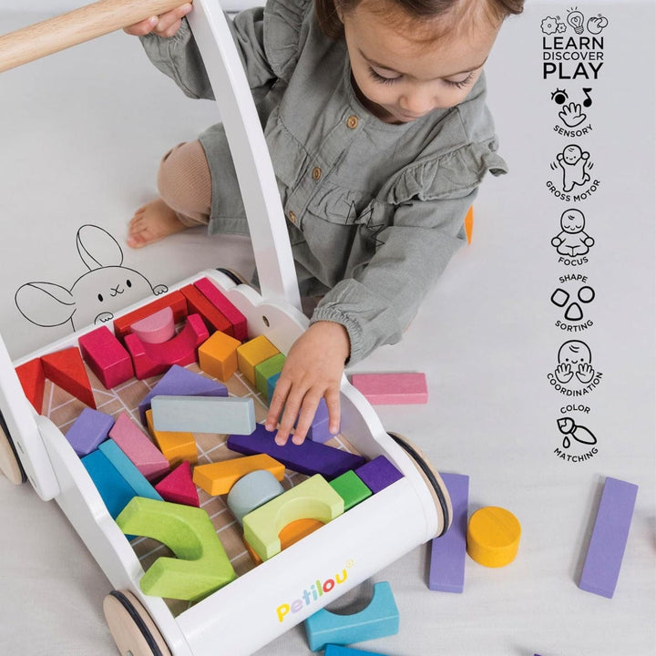 Child playing with colorful wooden blocks in a toy box, with 'petilou' branding visible.