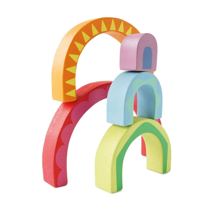 Colourful wooden arch-shaped toy blocks on a white background
