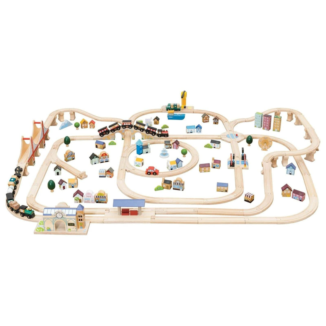 Wooden train set with tracks and small buildings on a white background
