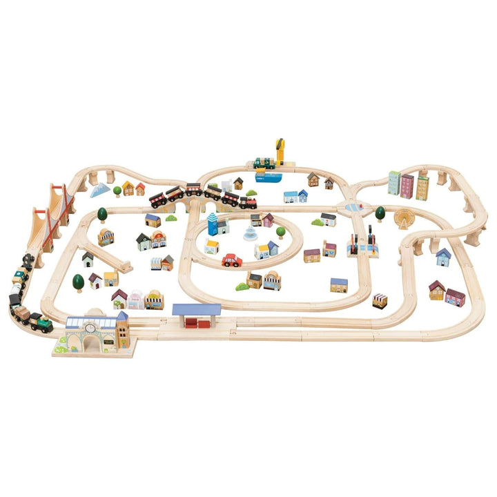 Wooden train set with tracks and small buildings on a white background