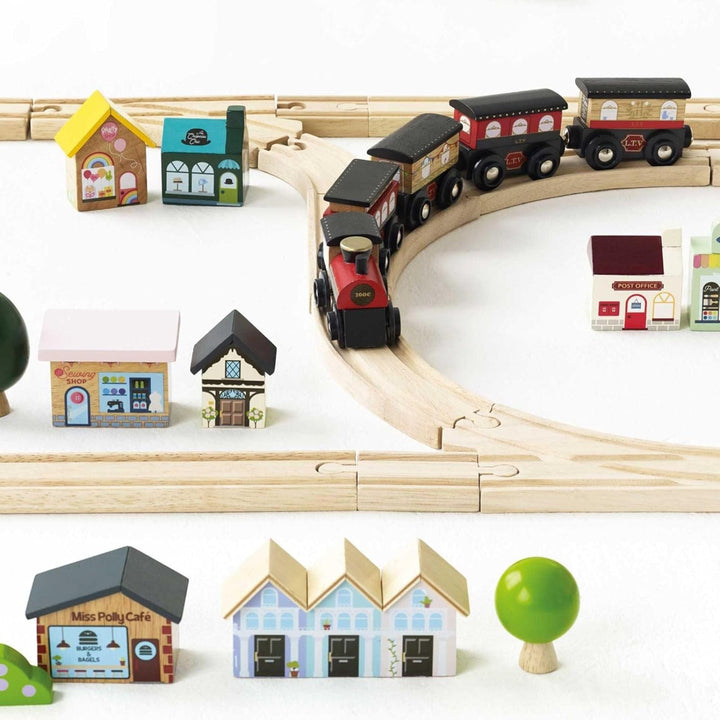 wooden train set with black colour train, little houses and shops and landscape blocks