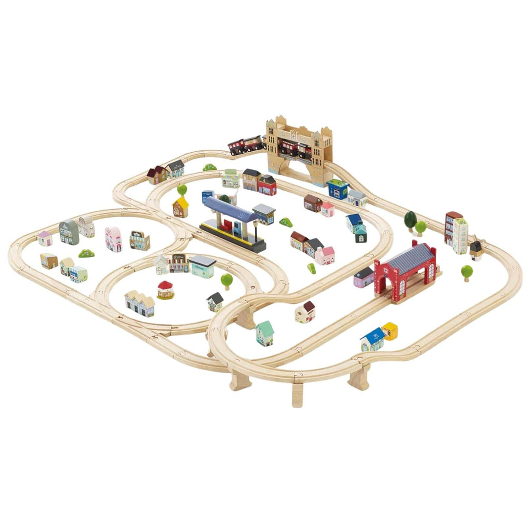 Wooden toy train set with tracks and buildings on a white background