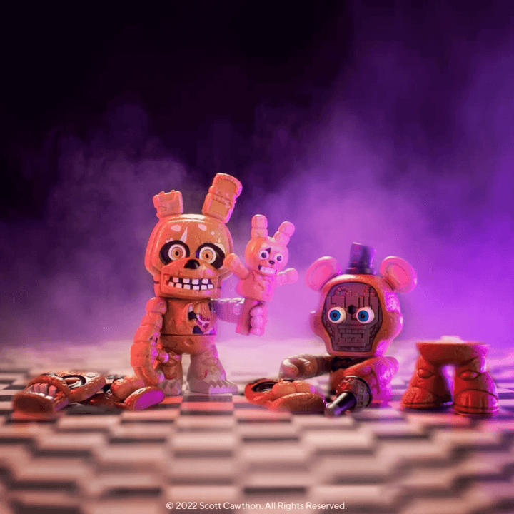 springtrap and freddy character figures in spooky room with face pieces on floow and springtap folding mini springtrap
