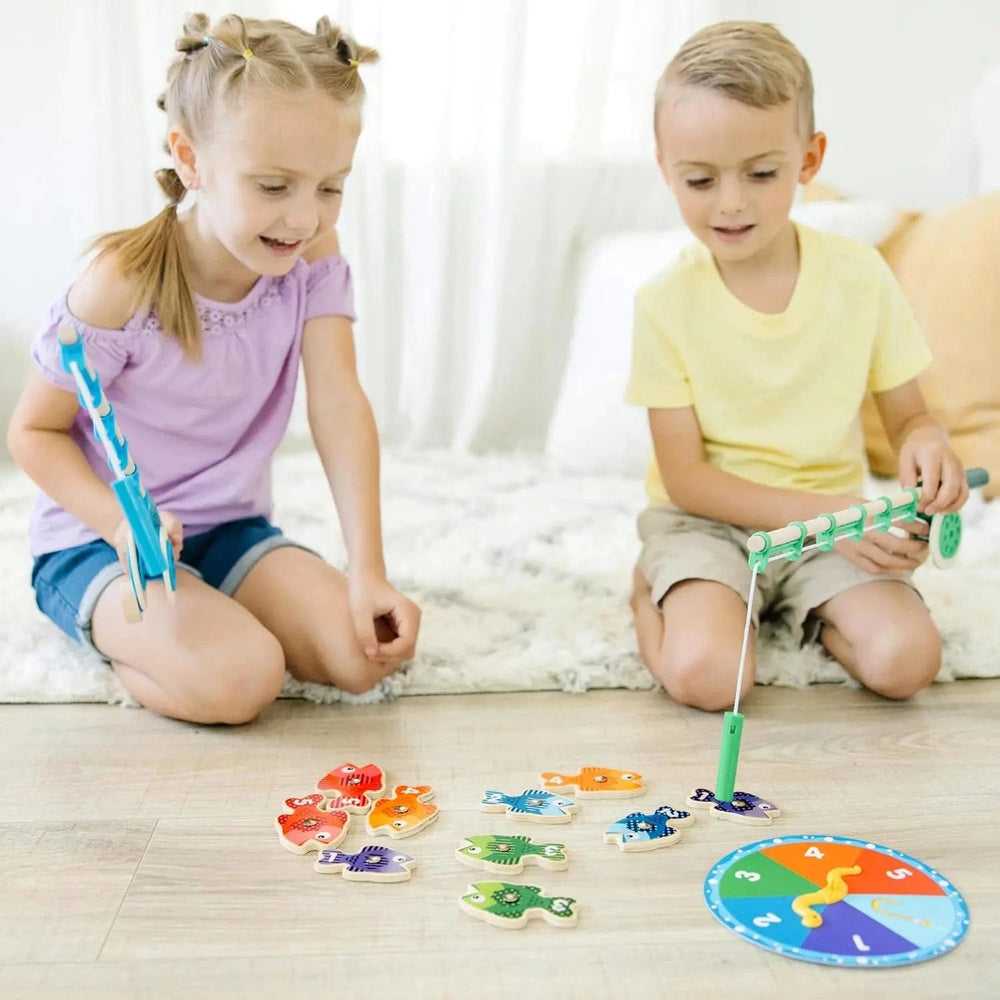 2 children playing Melissa & Doug Catch & Count Fishing Game with 2 wooden rods