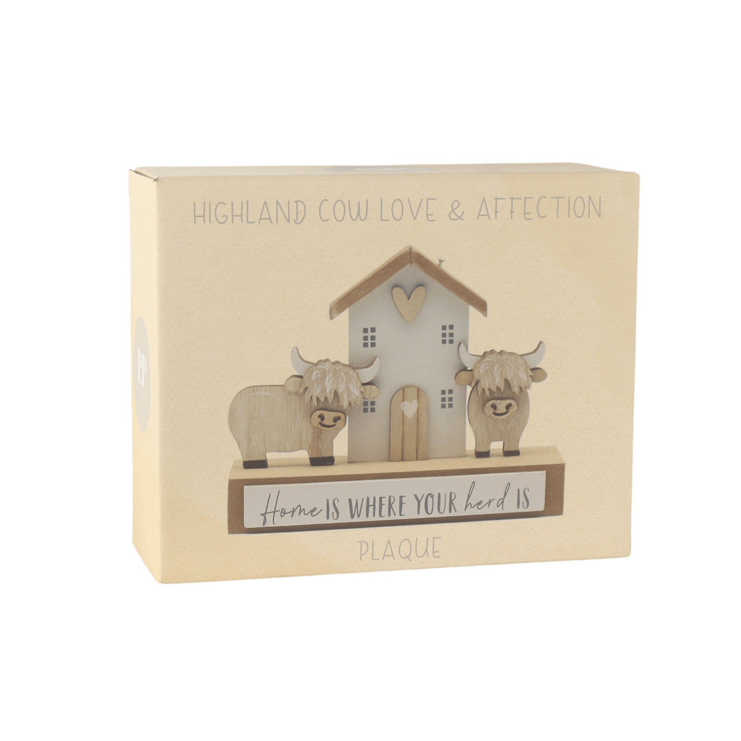 Decorative plaque with Highland cows and a house in packaging on a white background