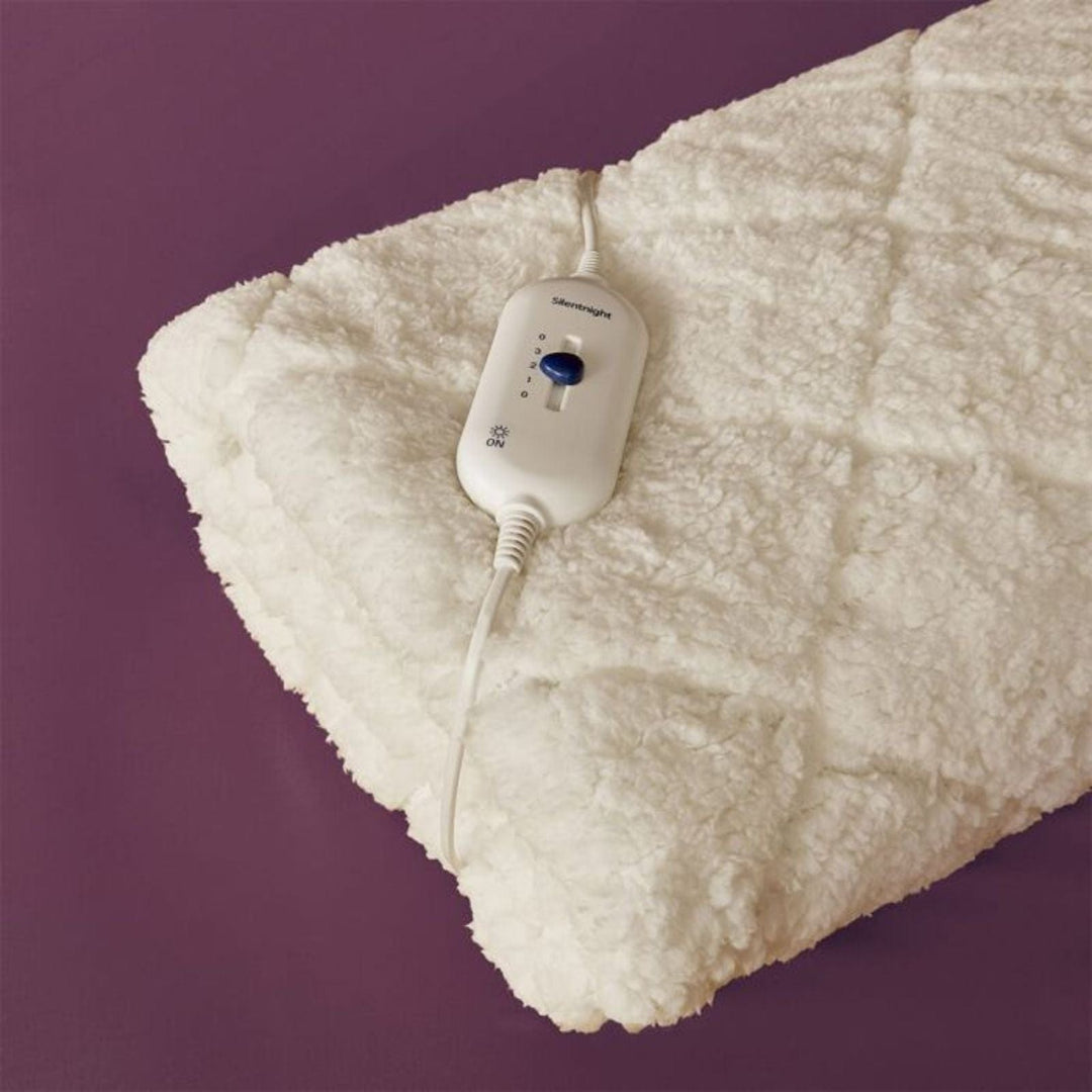 Heated blanket with a control unit on a purple background