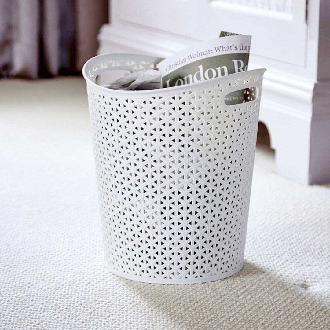 curver waste paper basket bin in bedroom space filled with magazines and newspapers