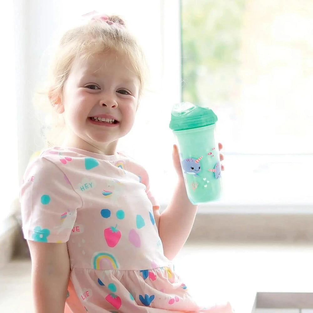 Girl holding an insulated bottle with narwhol design and flexible silicone rim spout