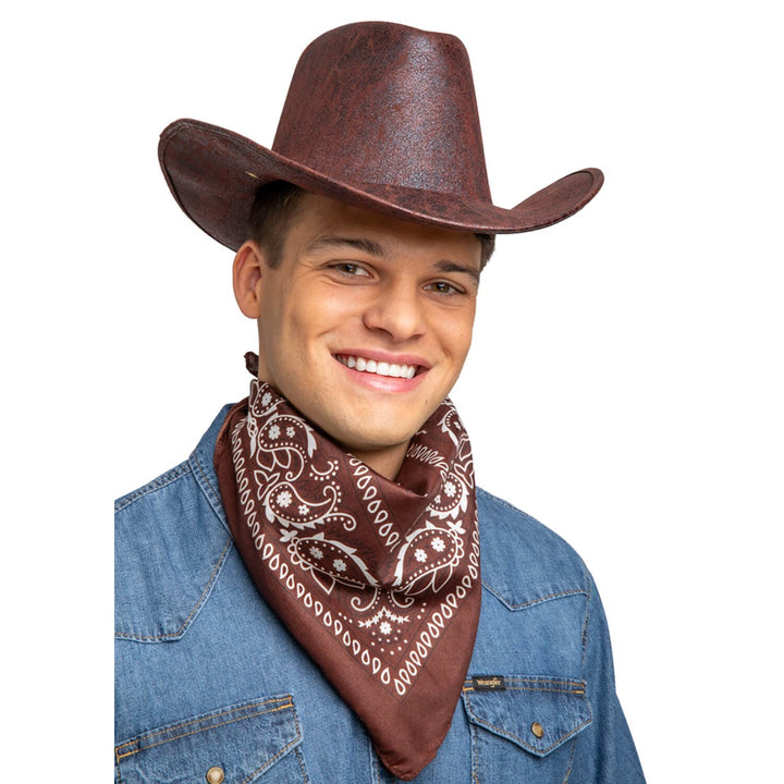 Man wearing a brown and white bandana and brown cowboy hat for fancy dress parties