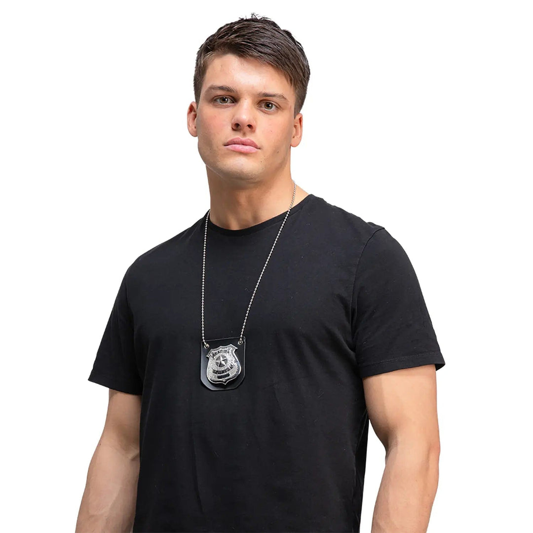 Man wearing a black t-shirt with police badge on a neck chain