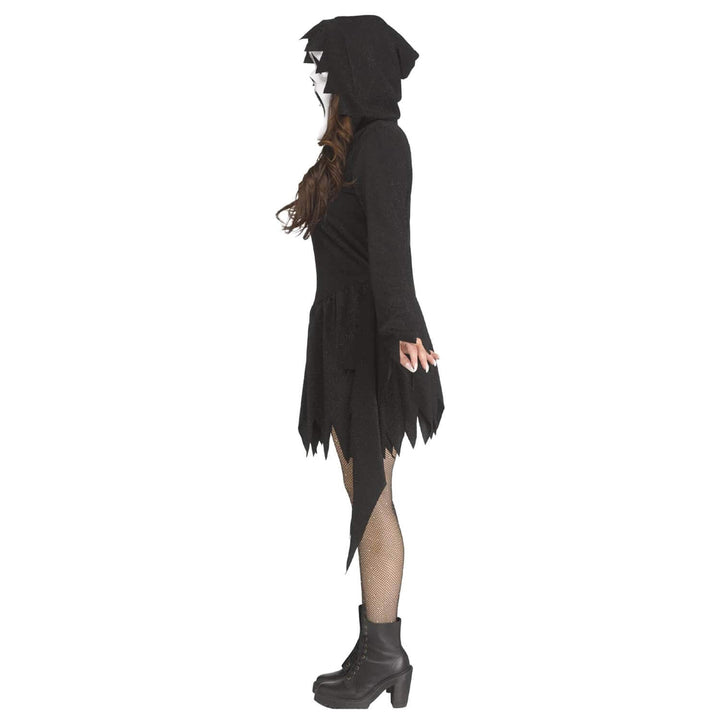 Side view of a woman wearing a black glitter fancy dress costume with black boots