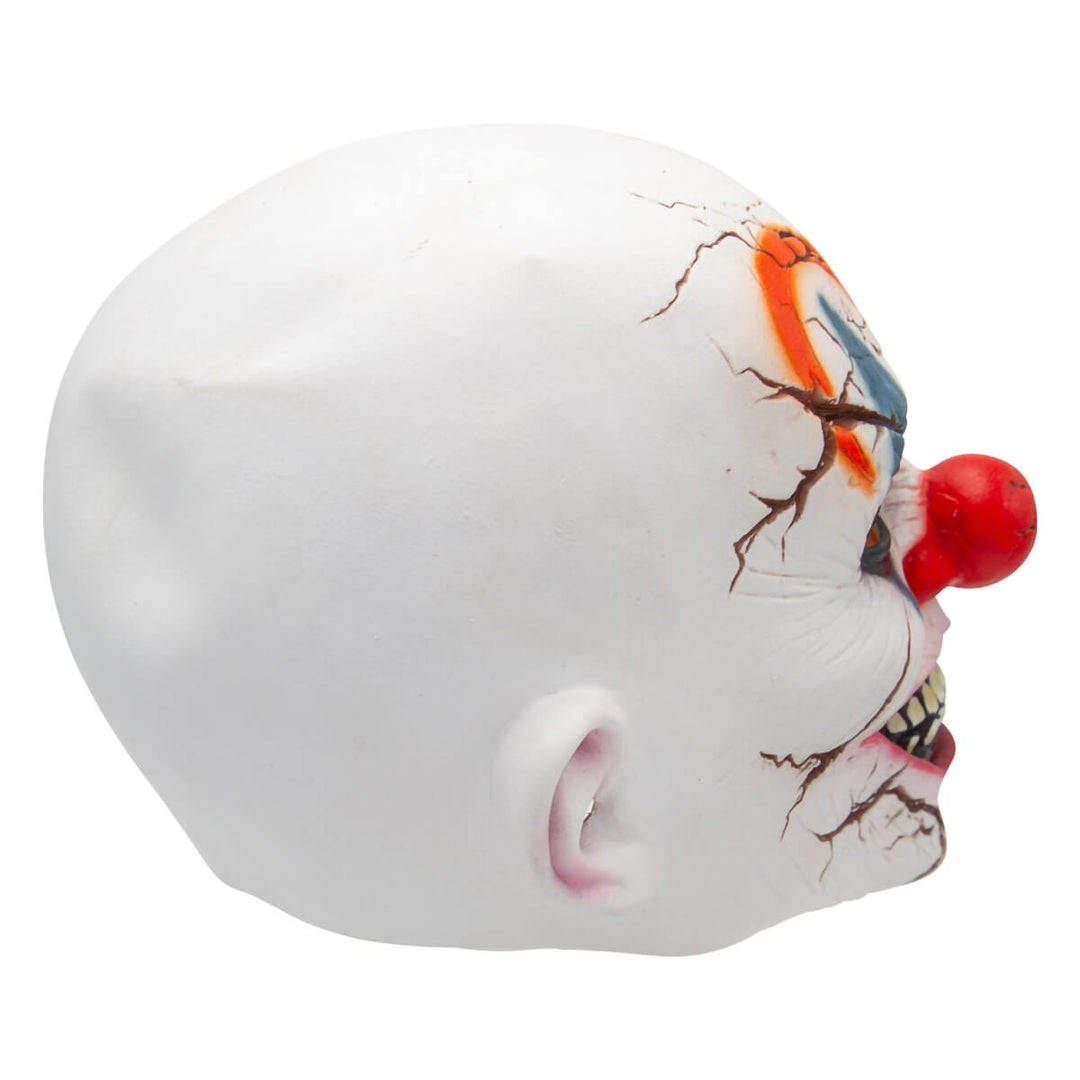 A white clown mask with a red nose, cracked facial details, and painted orange, blue, and black makeup around one eye, shown on a plain white background.
