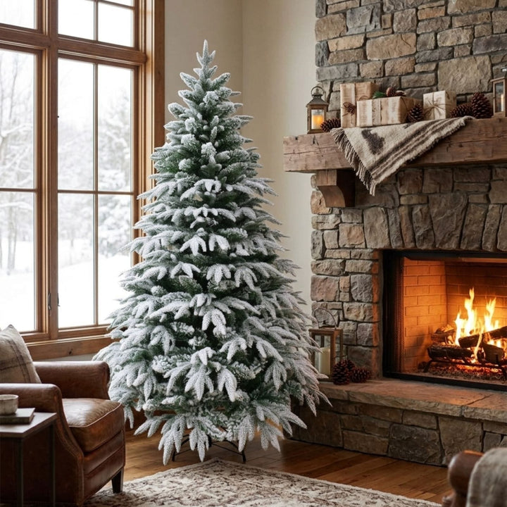 Frosted Christmas tree in a living room with a stone fireplace and snowy window view.