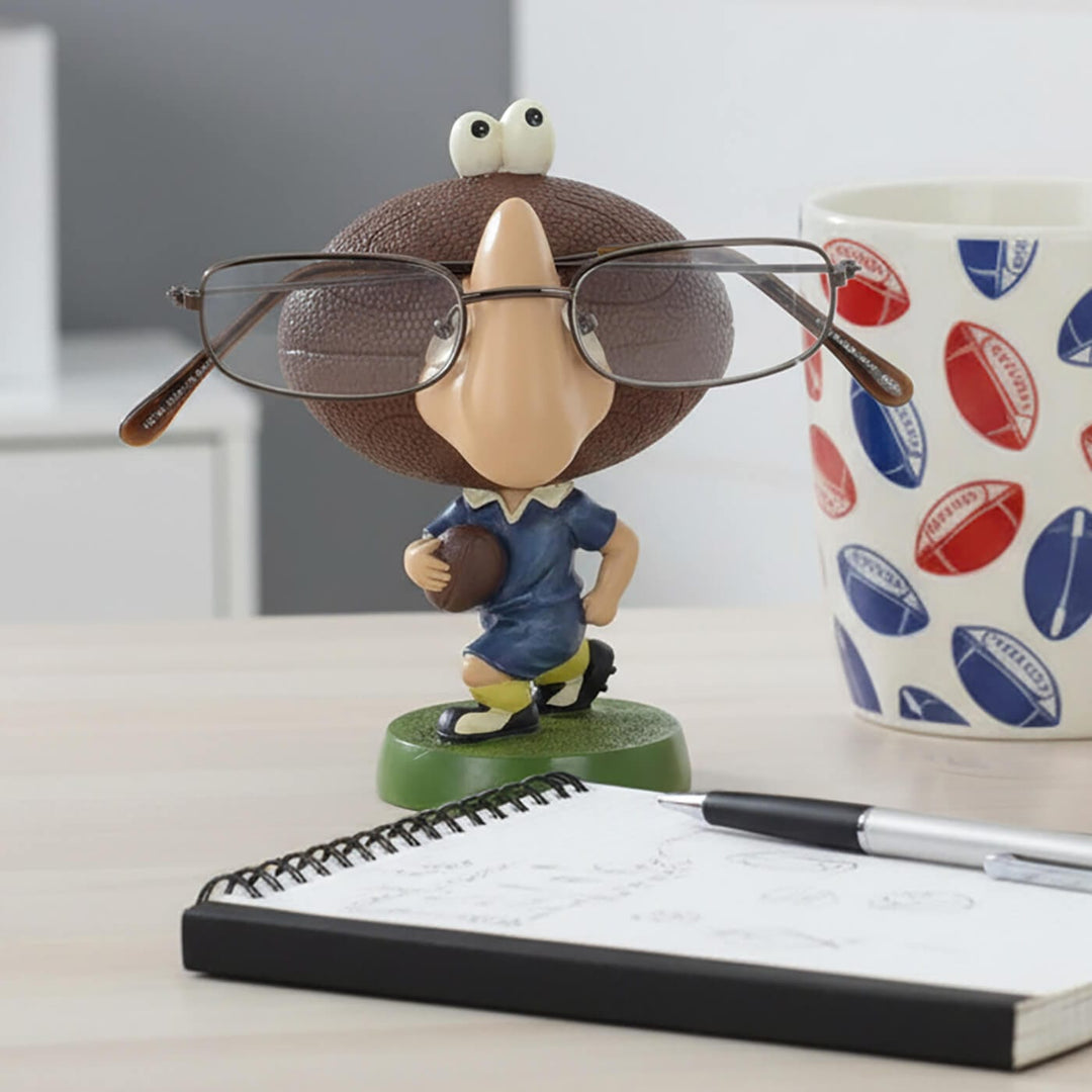 Rugby head figure glasses holder on a desk with rugby themed coffee mug