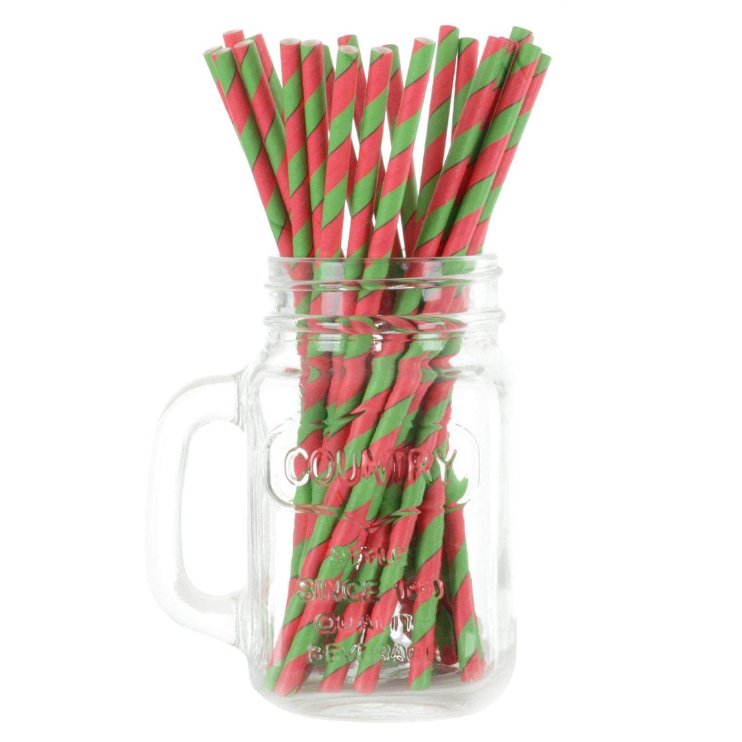 Red and green striped drinking straws in a glass mason jar on a white background