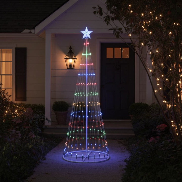 Decorative Christmas tree light fixture in front of a house with outdoor lighting.