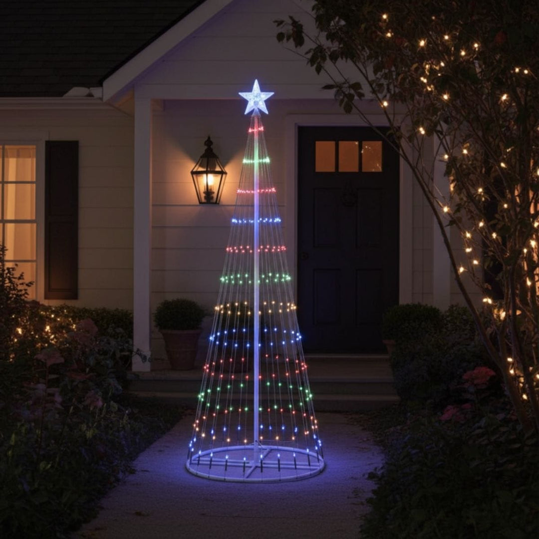 Decorative Christmas tree light fixture in front of a house with outdoor lighting.