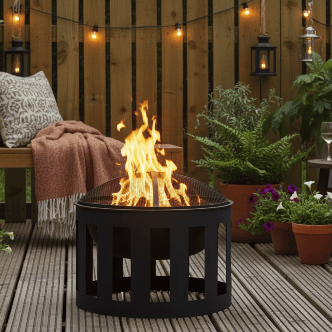 Fire pit on a wooden deck with plants and a bench in the background