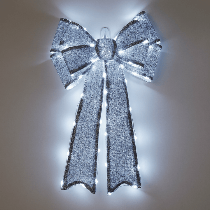Decorative silver bow with lights on a plain background