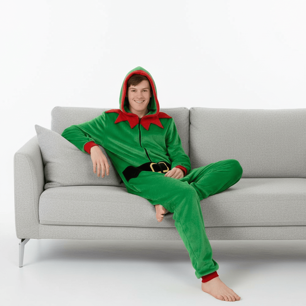 Person wearing a green elf onesie sitting on a gray couch.