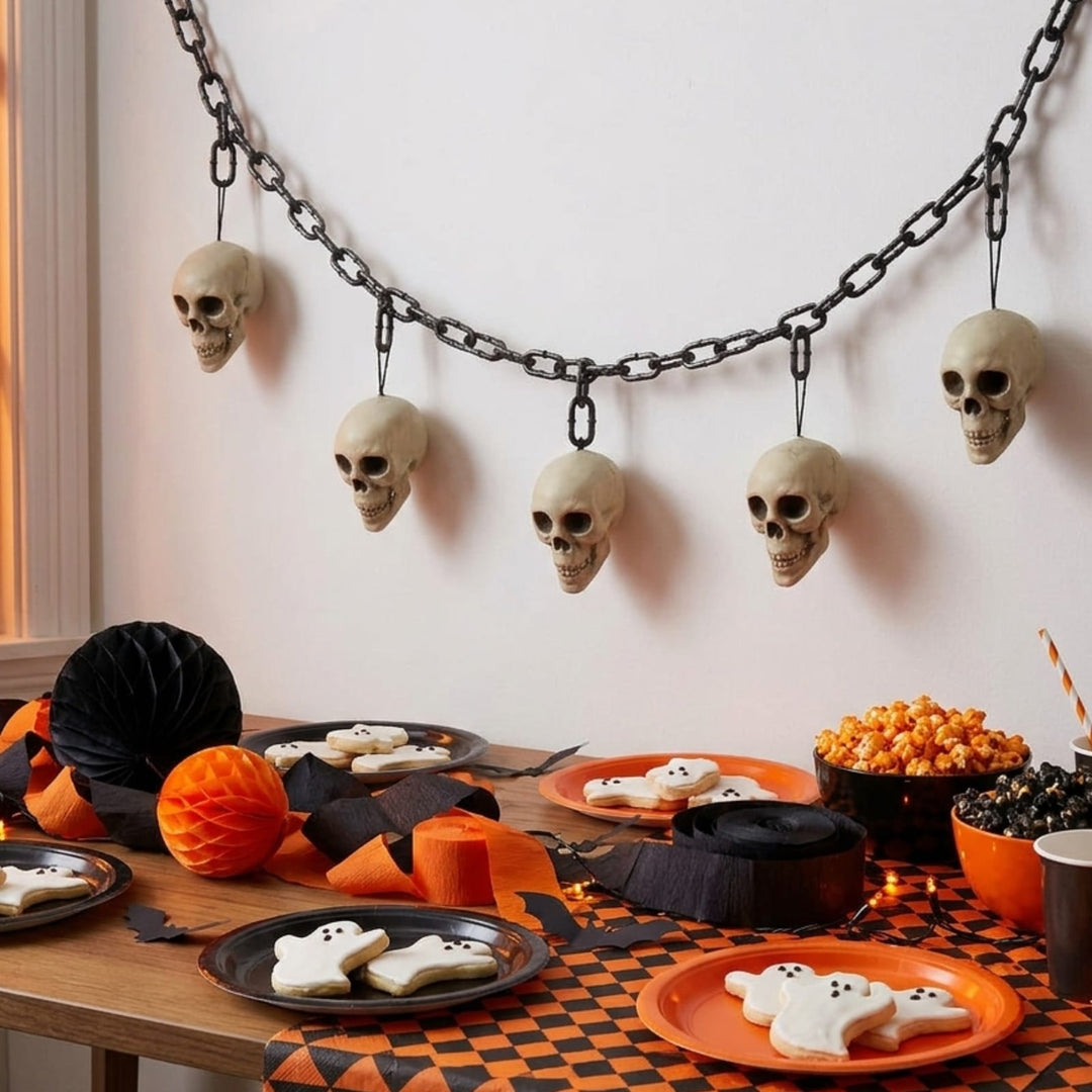 skull garland hanging on wall above halloween party table