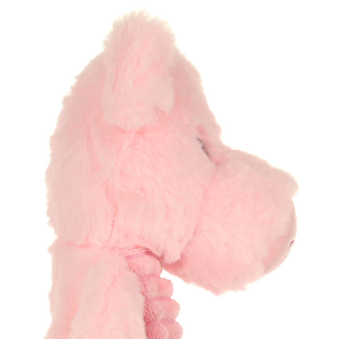 Close-up of a pink plush pig heat pack with a white background