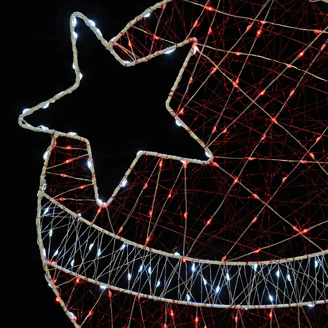 Close up of Christmas bauble silhouette lights with white star and red lights