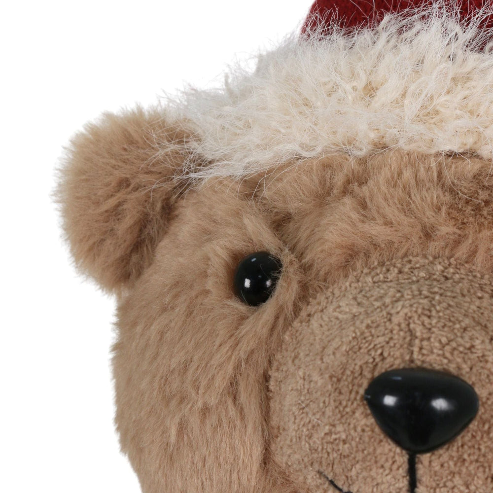 detail shot of teddy bear face with black nose and plush santa hat