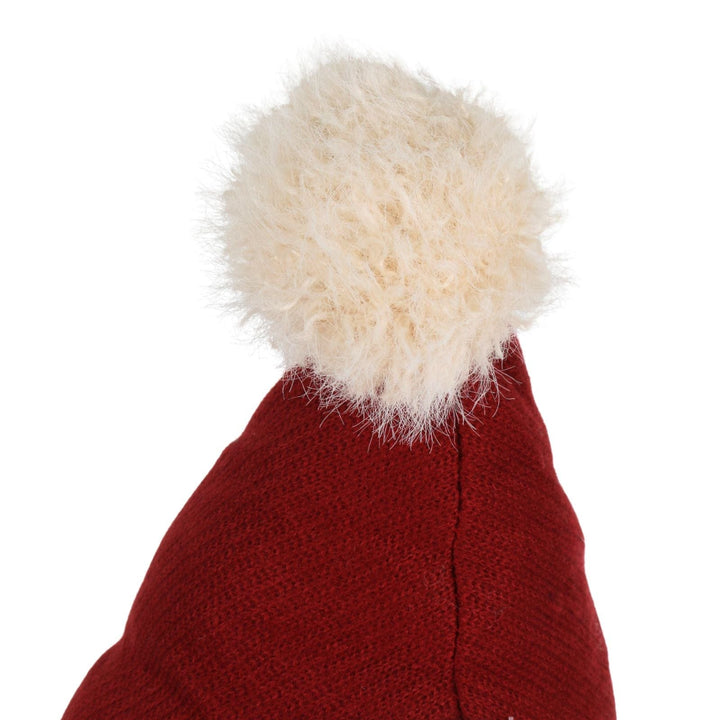 Close-up of a red knitted hat with a white fur pom-pom on a white background