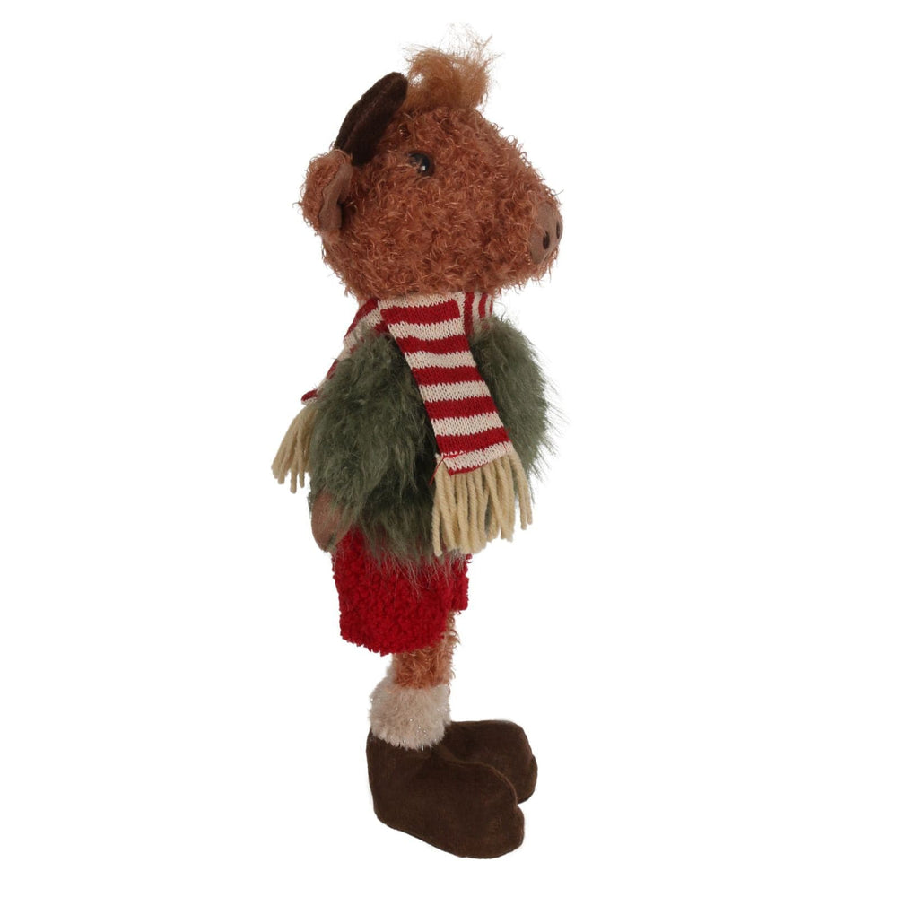 side view of highland cow figure wearing green fuzzy jumper