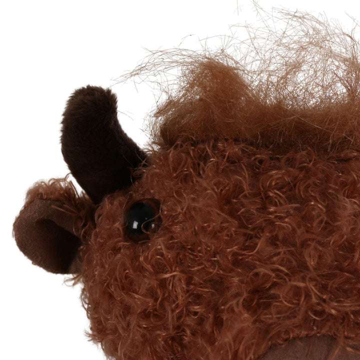 close up of highland cow figure with beaded eye and brown plush hair and horns