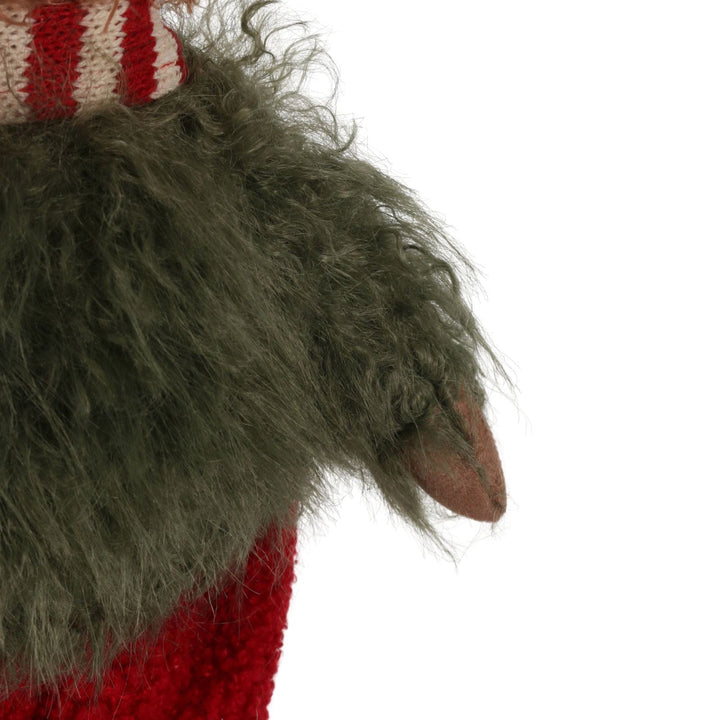 close of of green fluffy jumper on highland cow figure