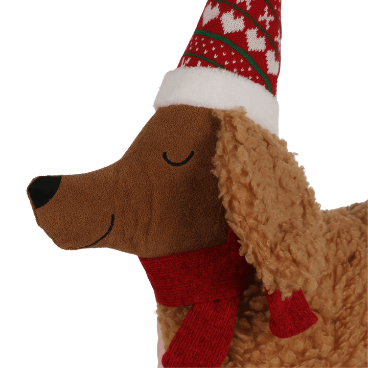 detail hot of face on dog christmas cushion with red and green santa hat