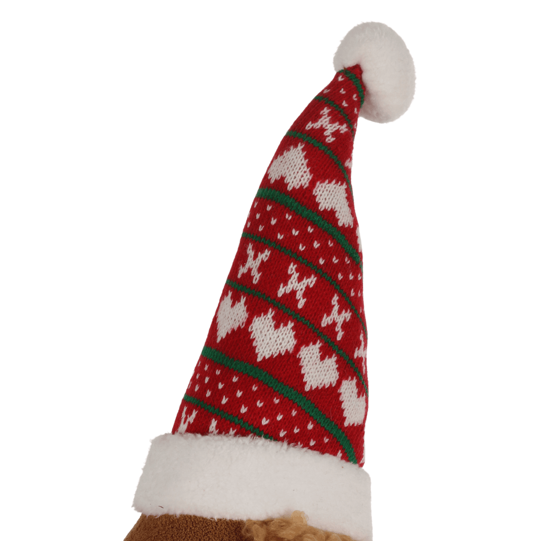 detail shot of red and green christmas santa hat with knitted detail and hear shaped patterns on dog cushion