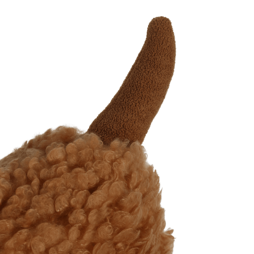detail shot of plush brown tail on christmas dog cushion