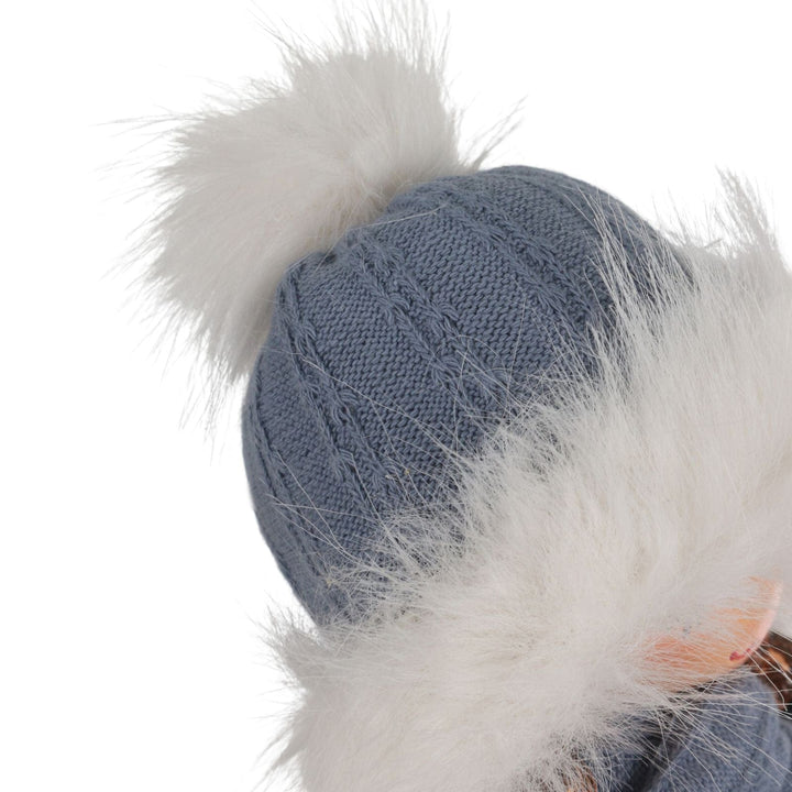 Blue knitted beanie with white fur trim on a white background
