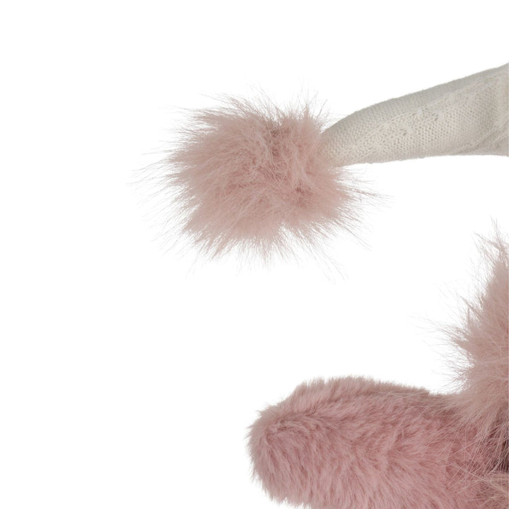 Close-up of pink fluffy pom pom on a white background
