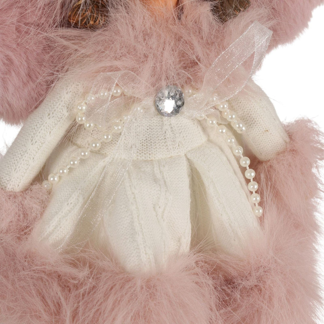 close up of angel dress with pearl ribbons and diamnate bow