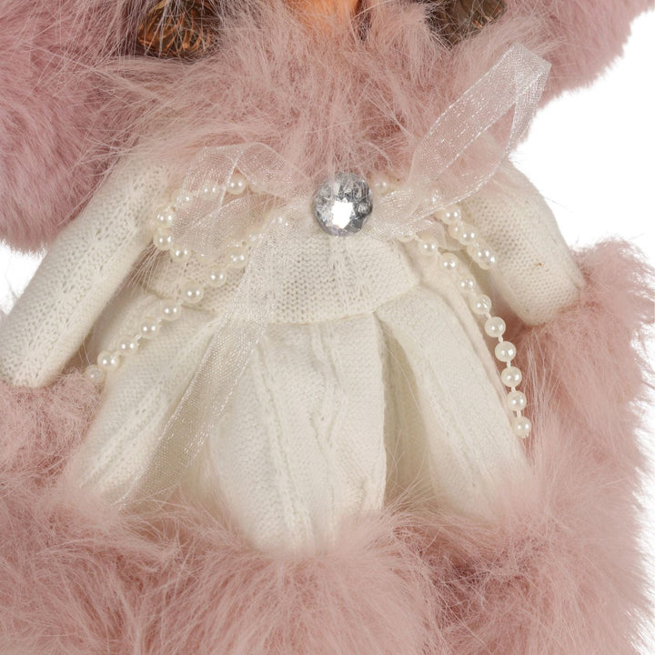 close up of angel dress with pearl ribbons and diamnate bow