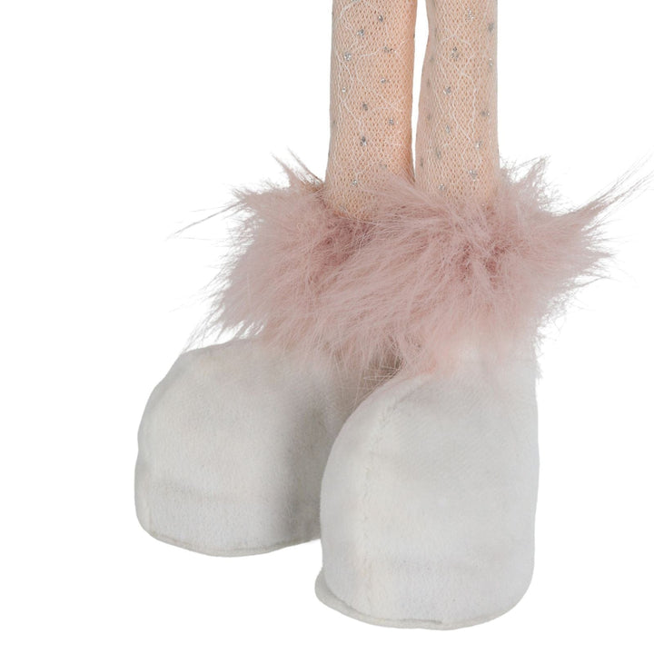 White shoes with pink fluffy accents on a white background