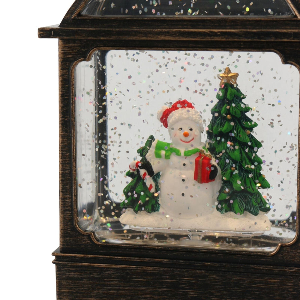 Decorative snowman with a tree and gift in a glass box with antique bronze frame.