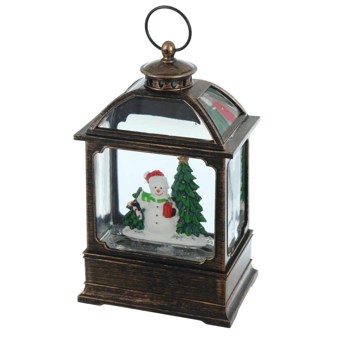 Decorative lantern with a snowman and Christmas tree inside on a white background