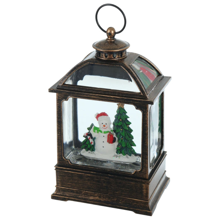 Decorative lantern with a snowman and Christmas tree inside on a white background