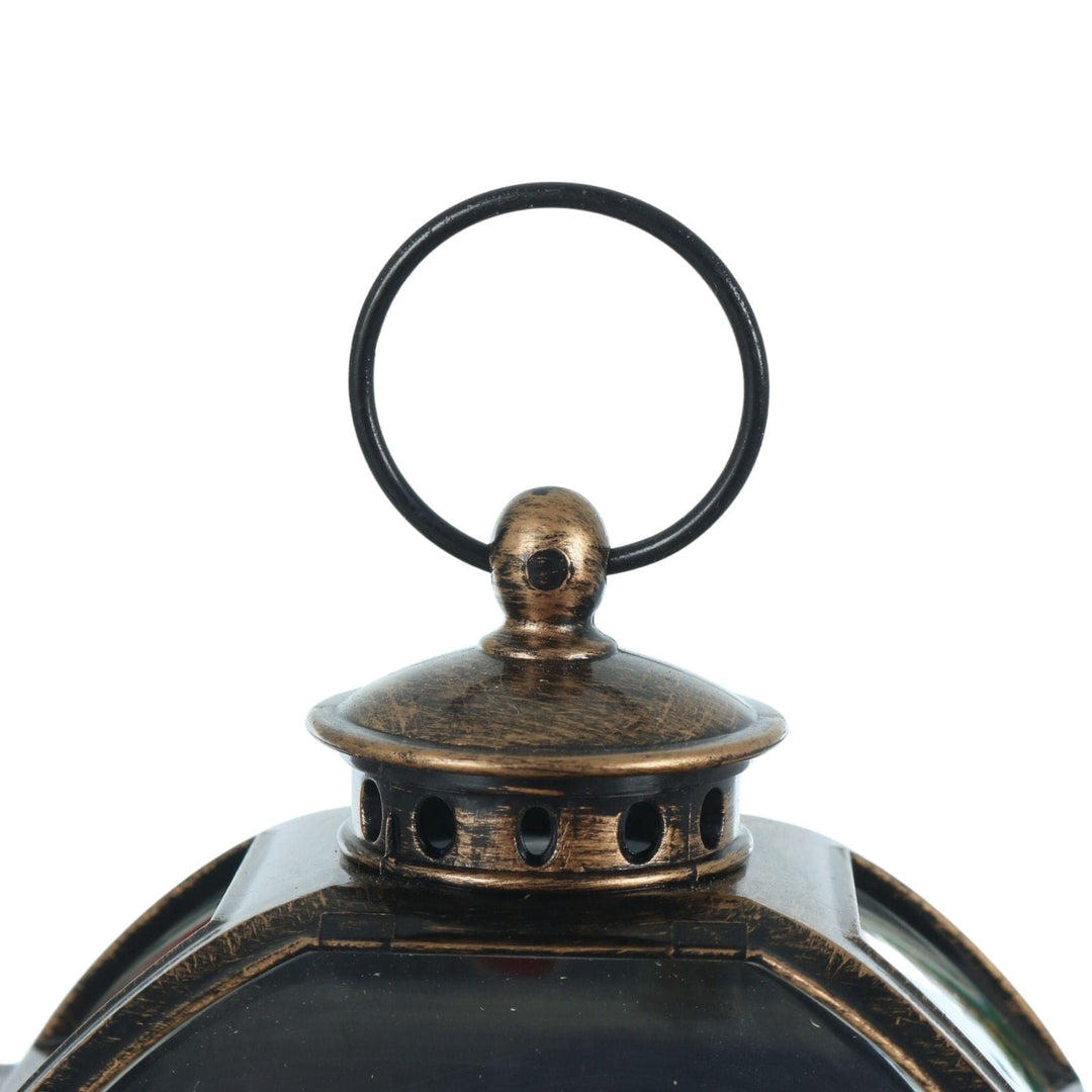 Bronze lantern with a black handle on a white background