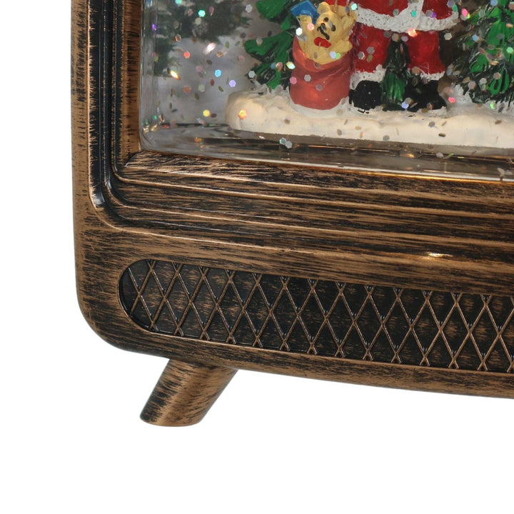 Decorative Christmas scene with a retro tv frame and festive elements.