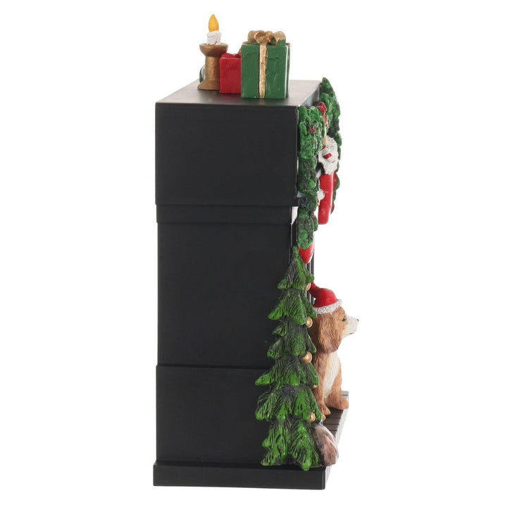 side view of chritmas fireplace scene with tree and presents on top